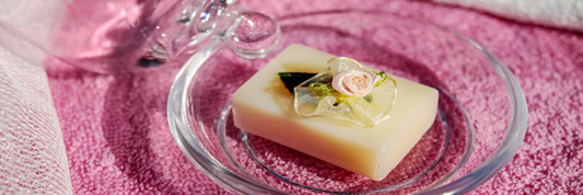 A new bar of soap with a floral detail, positioned on a glass dish. Sourced from Pexels.