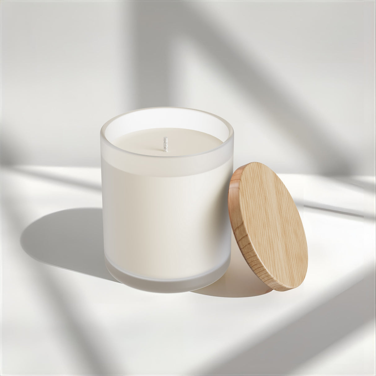 White candle in a glass jar with a wooden lid on a light background