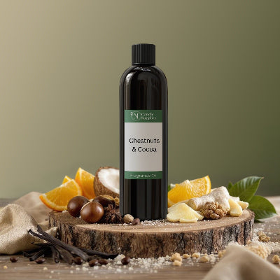 Bottle of 'Chestnuts & Coconuts' on a wooden stand with vanilla beans and oranges on a green background