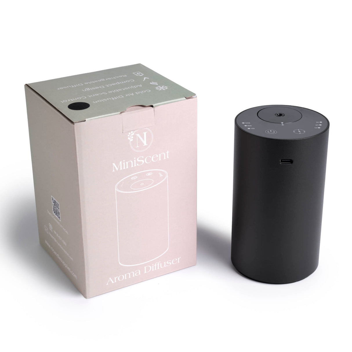 Black aroma diffuser next to its packaging on a white background