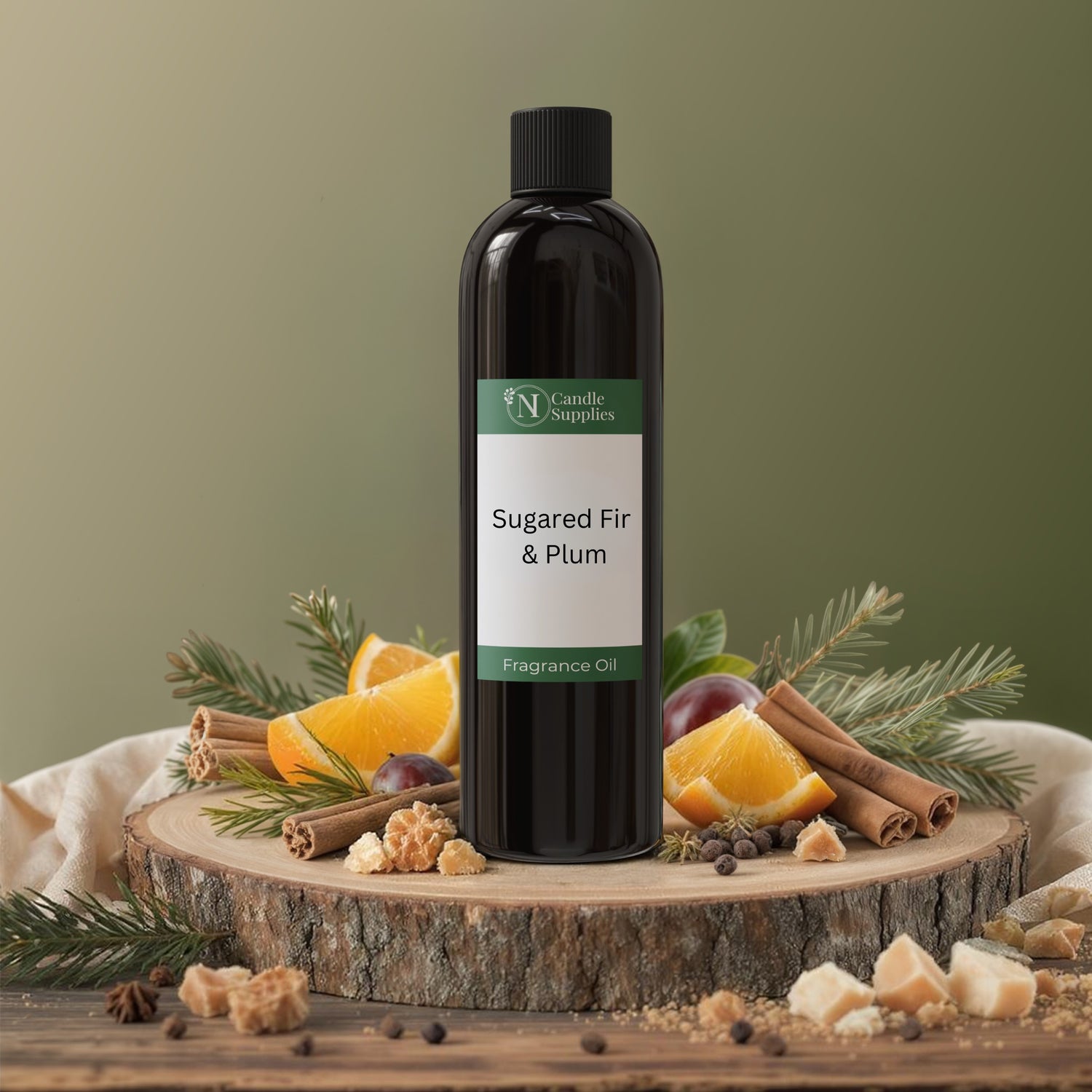Bottle of Sugared Fir & Plum fragrance oil on a wooden platform with festive ingredients.
