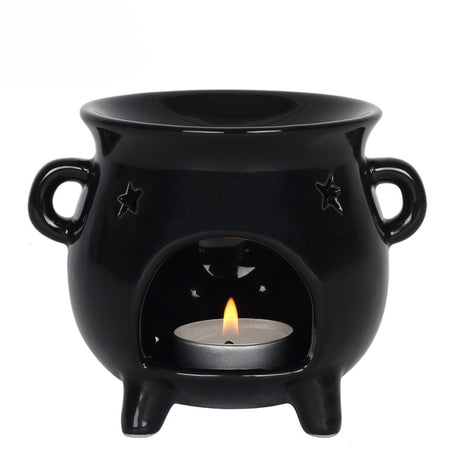 Black ceramic oil burner with a lit tealight candle on a white background