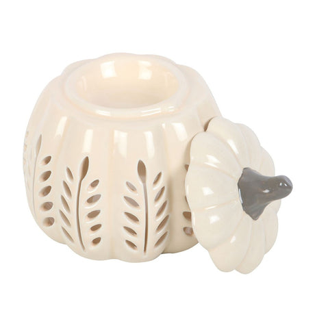 White ceramic pumpkin-shaped wax melt burner with a grey stem on a white background