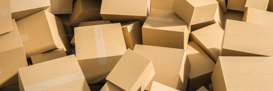 An overhead shot of boxes piled on top of eachother. Sourced from Unsplash