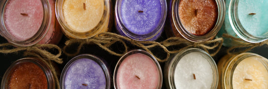 An above shot of different coloured candles, each with a glittering effect
