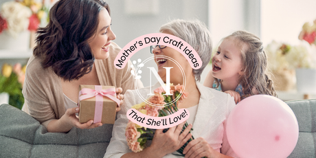 A workspace full of crafting supplies used to make a handmade bookmark.