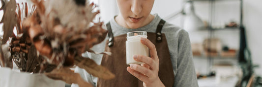 Close-up shot of an artisan smelling a homemade candle. Sourced from Pexels.