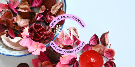 Colourful, dried flowers such as sprigs of lavender and rose petals on a wooden table