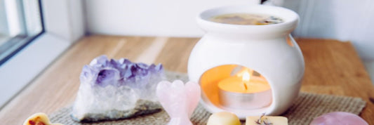 A tealight wax melt burner surrounded by crystals and mini floral wax melts. Image sourced from Prima.
