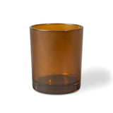 Amber glass candle tumbler on a white background