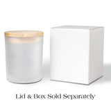 Frosted candle vessel with wooden lid next to a white box on a white background