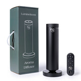 Black aroma diffuser with remote control and packaging on a white background