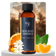 Bottle of Skylight Essence with oranges, flowers, and leaves on a scenic background