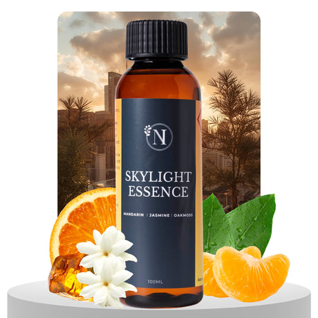 Bottle of Skylight Essence with oranges, flowers, and leaves on a scenic background