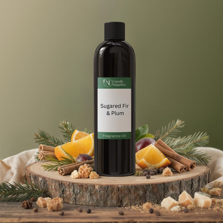 Bottle of Sugared Fir & Plum fragrance oil on a wooden platform with festive ingredients.
